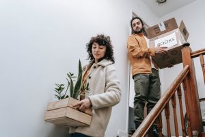 A couple carrying boxes