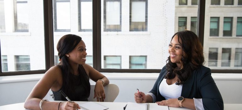 Women talking near office window