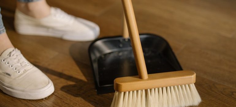 woman in white snickers cleaning the floor