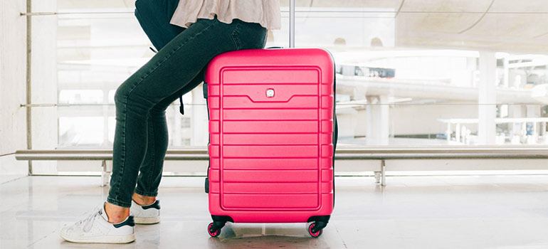 a woman sitting on a suitcase