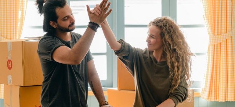 A man and a woman are clapping hands.