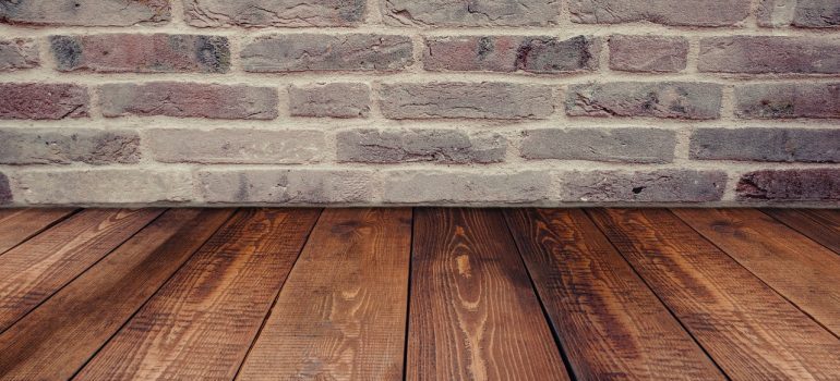 Beautiful wooden floor next to a brick wall