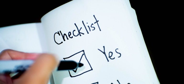 Person checking boxes on a checklist.