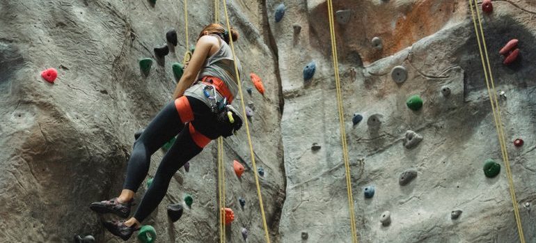 woman climbing wall