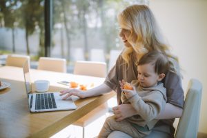 Woman carrying her child while thinking about moving to Weston as a single parent