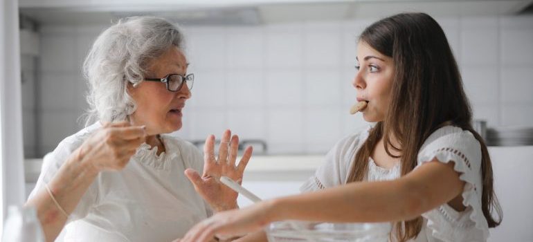 older woman and young girl talking