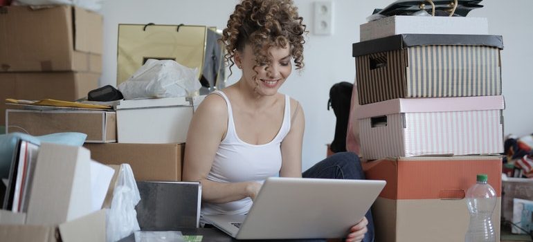 A woman decluttering her home thinking what to leave behind when packing for relocation to Lake Worth