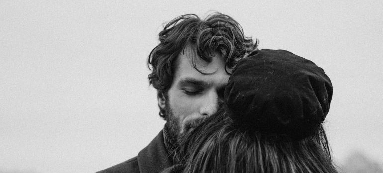 man and woman hugging