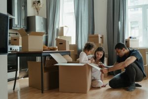 a family busy with unpacking boxes in the kitchen