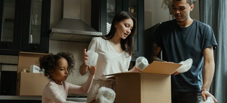 A family unpacking the boxes after the move from Brickell To Wilton Manors