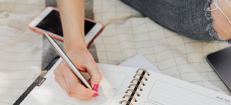 a woman writing in her notebook