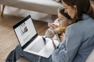 Woman and her daughter using a laptop