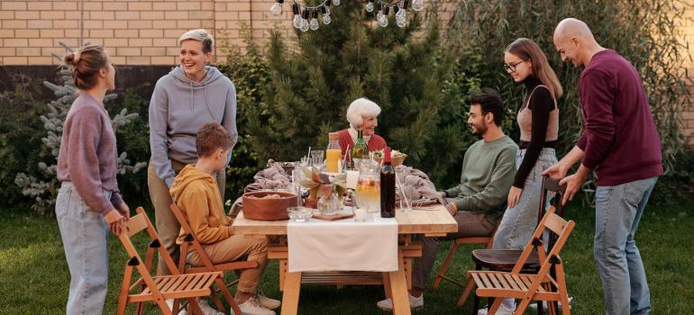 A family is gathered in a yard