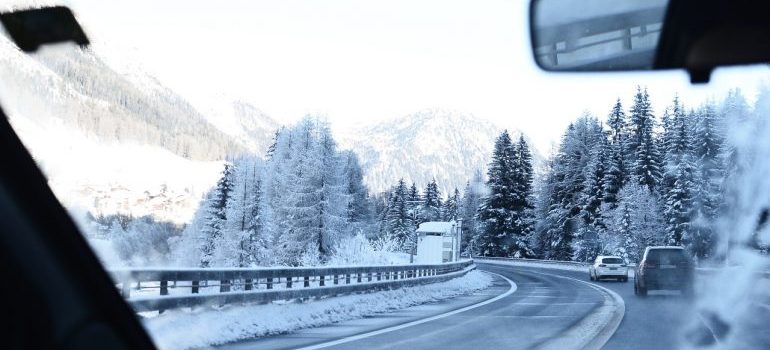 Person driving on an icy road after moving to a colder climate