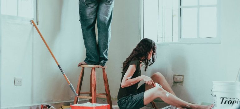 a couple painting a home together