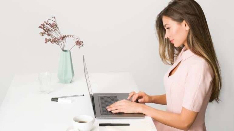 woman looking at computer trying to plan a relocation while working full-time