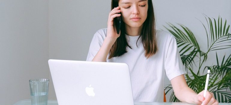 A woman cancelling her move over the phone