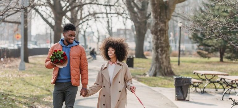 A couple taking their dog for a walk