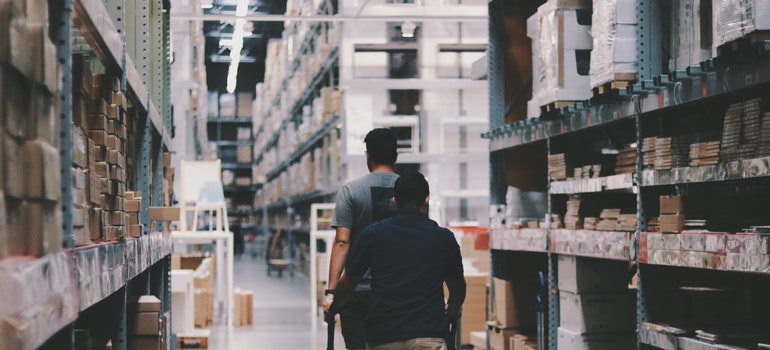 two guys going through a big warehouse