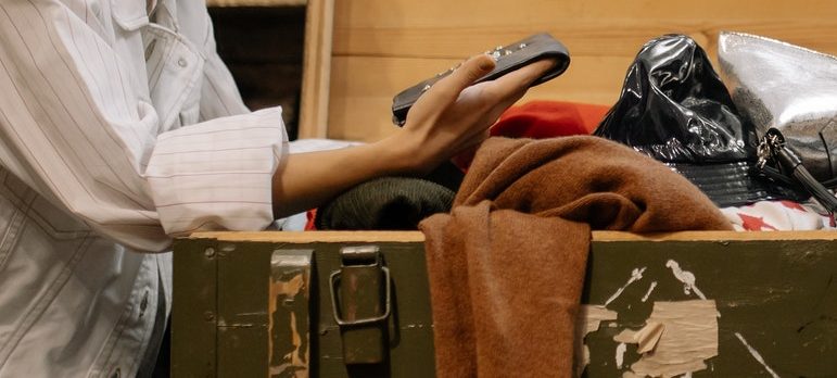 a woman shuffling through old items