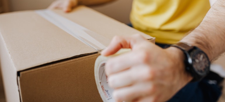 Mover packing a box.