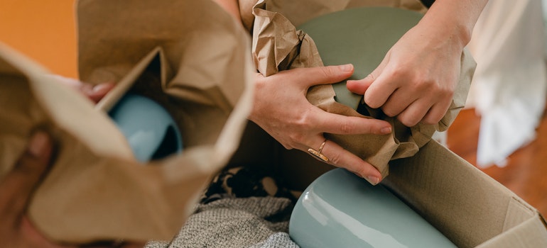 a person packing ceramic ceramic tableware 