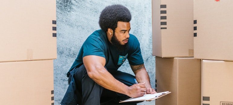 mover evaluating cardboard boxes