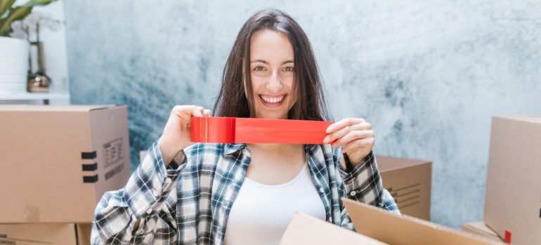 a woman holding a packing tape