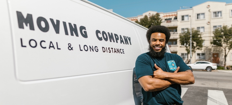 Movers standing next to the van.