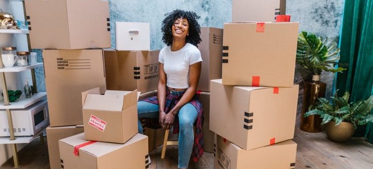 Woman sitting surrounded by boxes