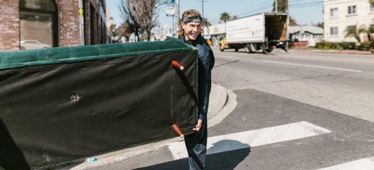 A mover carrying a couch