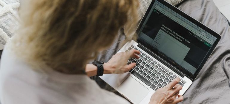 Person is using their laptop for research before their relocation from Miami Beach to Miami downtown