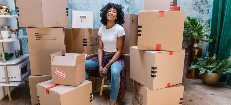 girl smiling around boxes