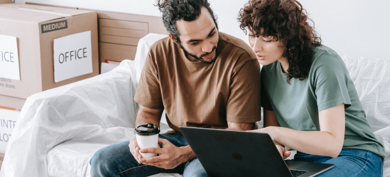 two parents sitting on the couch while planning, to depict how you should prepare your family for interstate relocation from Florida