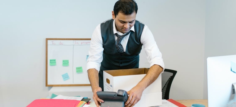 A man packing his desk