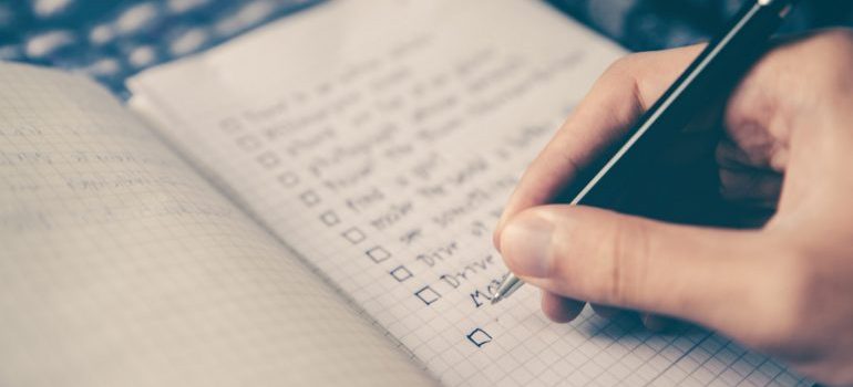 A man writing a checklist