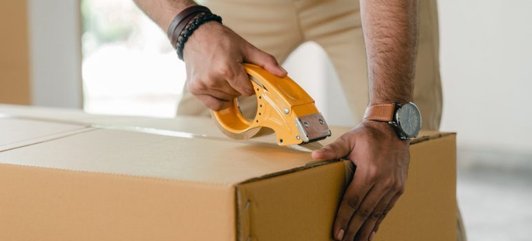 A person packing a moving box