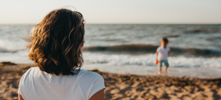 A woman and a child on the beach 