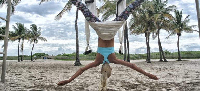 a woman exercising on the beach