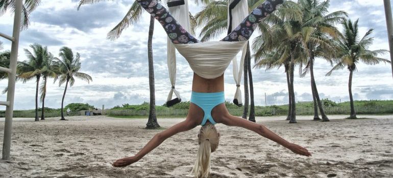  a woman exercising on the beach