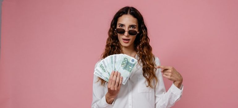 a woman holding paper money