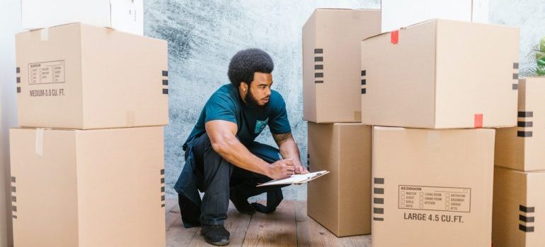 A person thinking about last-minute packing tips for your Florida relocation while looking at professional mover
