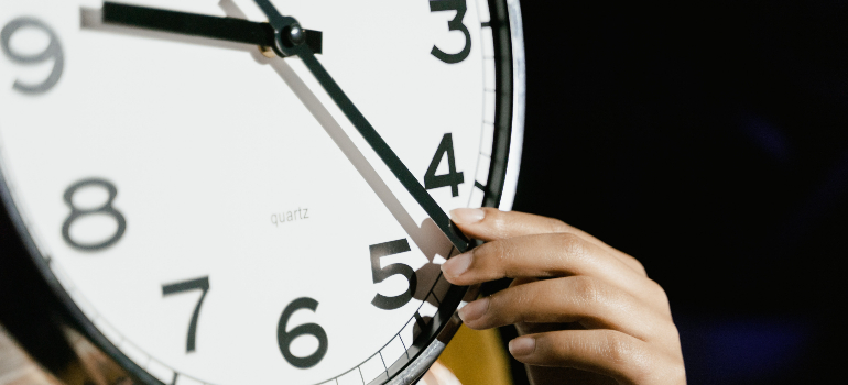 A woman moving clock hands