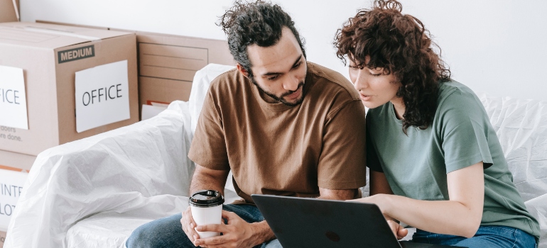 a couple looking at a computer