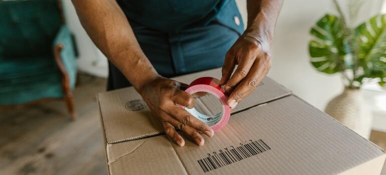 A person packing a moving box