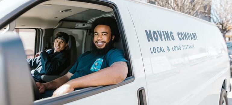 Movers inside their moving van