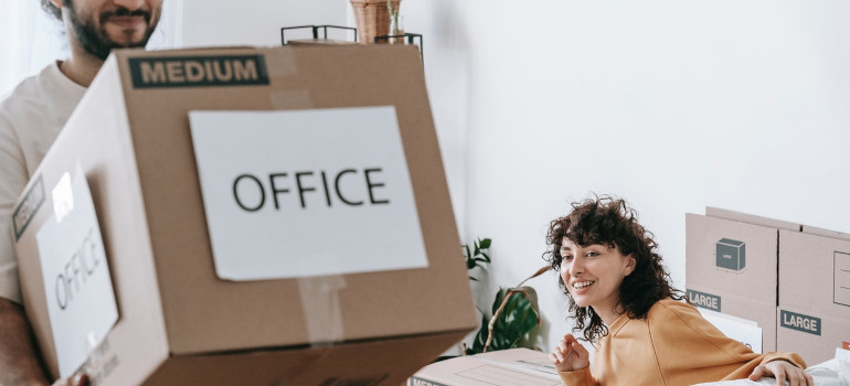 Man carrying a box labeled office