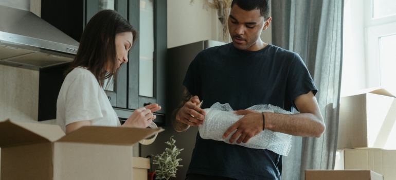 A couple packing up the kitchen 