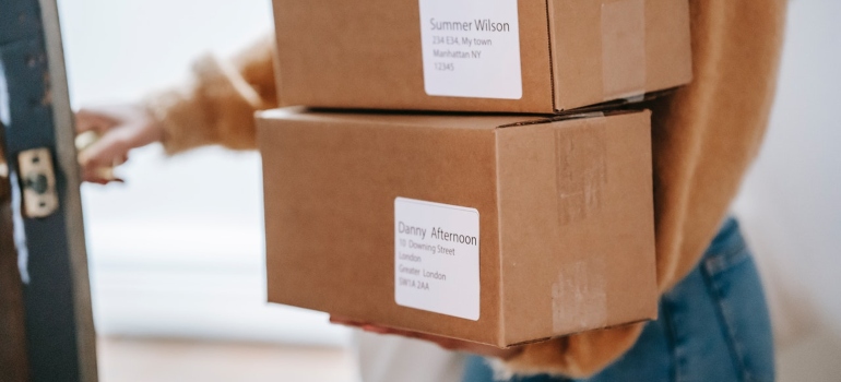 A woman taking labelled boxes 