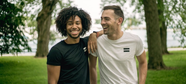 Friends laughing in the park enjoying the cultural diversity which is one of the reasons why expats love Hallandale Beach 